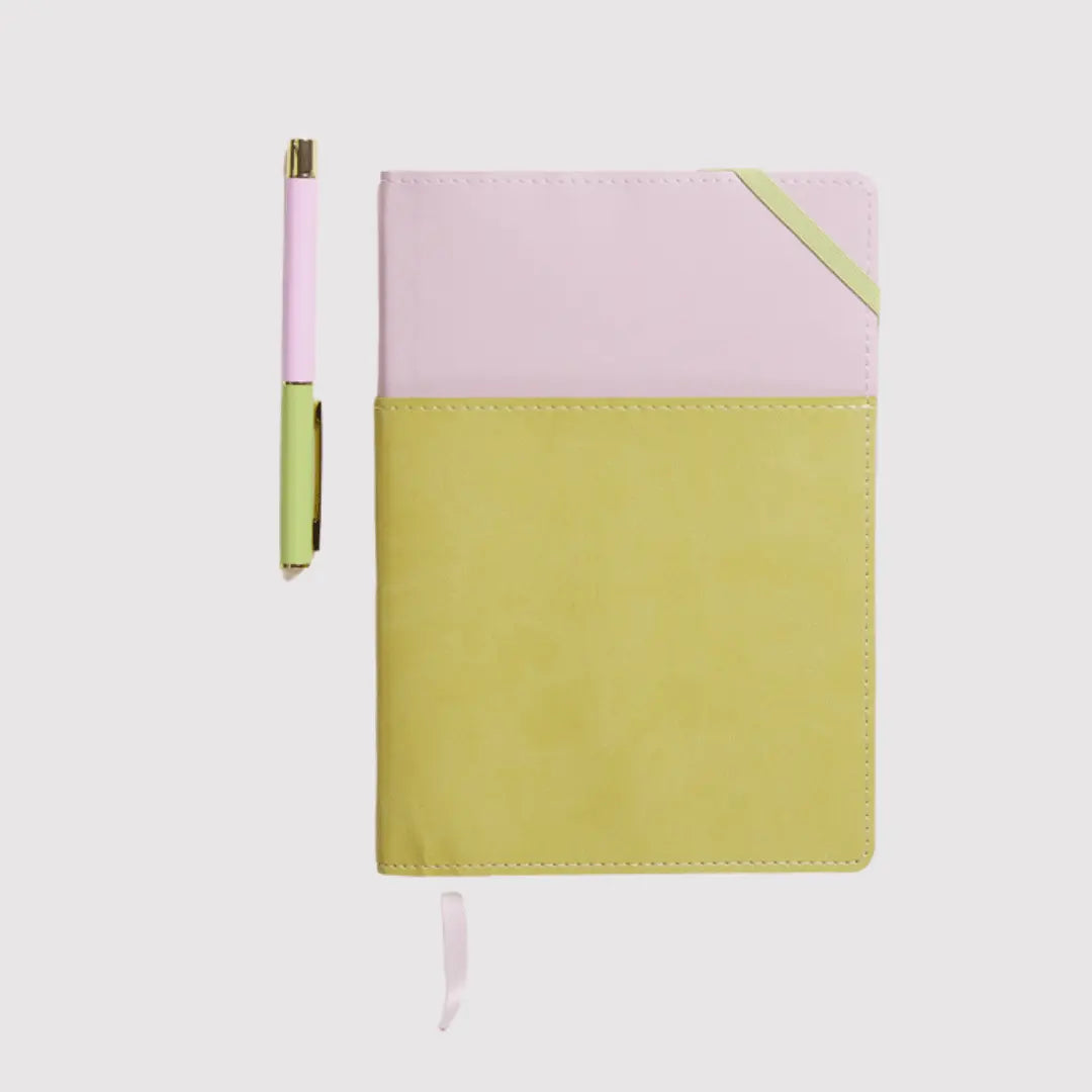 A closed Journal + Pen Bundle (Lilac) featuring a lilac vegan leather cover and matching pen to the left, crafted from eco-friendly materials, displayed on a white background.