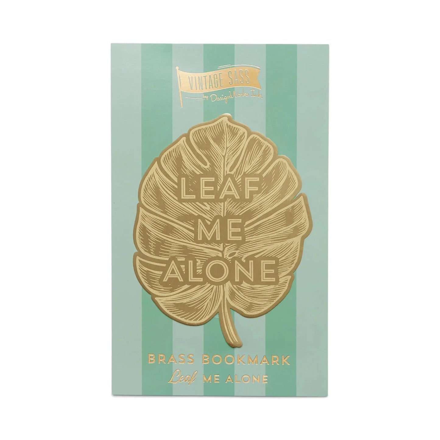 The Vintage Sass Brass Bookmark - Leaf Me Alone boasts a gold-finished brass leaf shape and the phrase LEAF ME ALONE, presented on a green striped card labeled VINTAGE SASS and BRASS BOOKMARK.