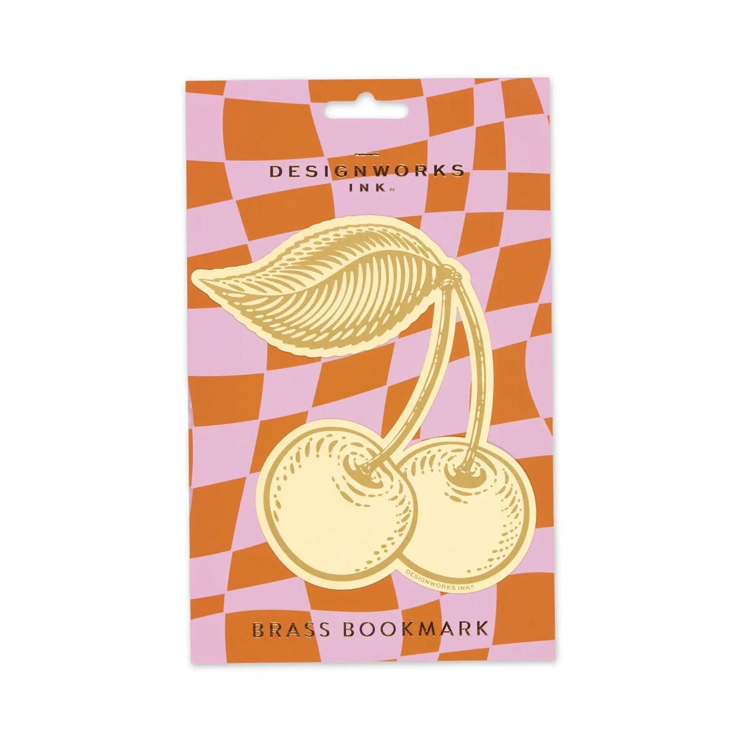 The Brass Bookmark - Cherries features a gold brass cherry design with leaves, displayed on orange and pink checkered packaging, and adds sophistication to your bookmark collection.
