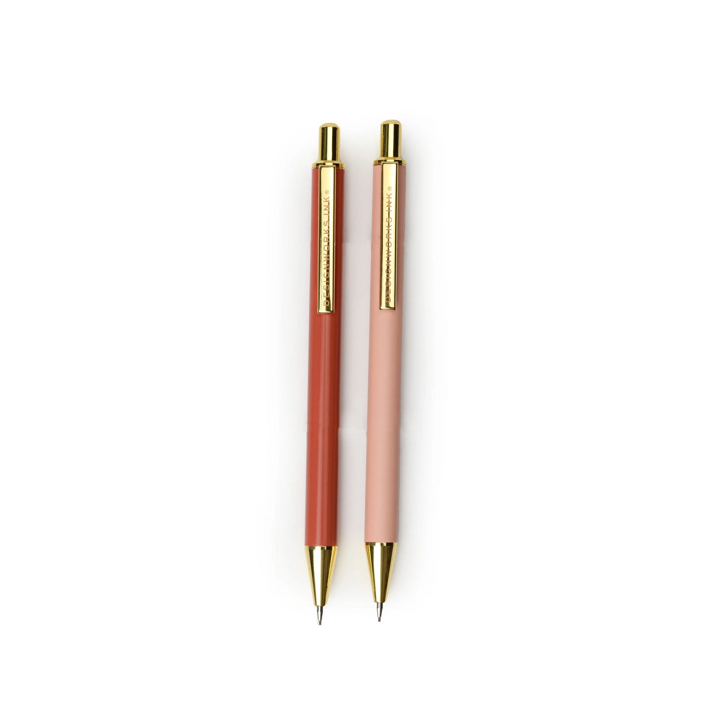 The Mechanical Pencils - Rosewood + Blush, featuring gold clips and accents in dark and light pink shades, are displayed side by side on a white background, offering a stylish writing experience with smooth 0.7mm lead.