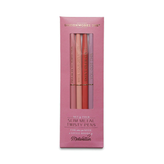 The Slim Metal Twisty Pens - Motivation set includes four sleek pink pens in a stylish box, each featuring gold foil designs and motivational phrases in various pink shades.