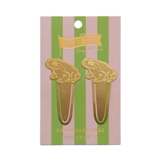 Two gold-finished brass frog-shaped page tabs from Vintage Sass, named Frogret about it, are attached to a pink and green striped backing card—stylish bookmarks with a modern flair.
