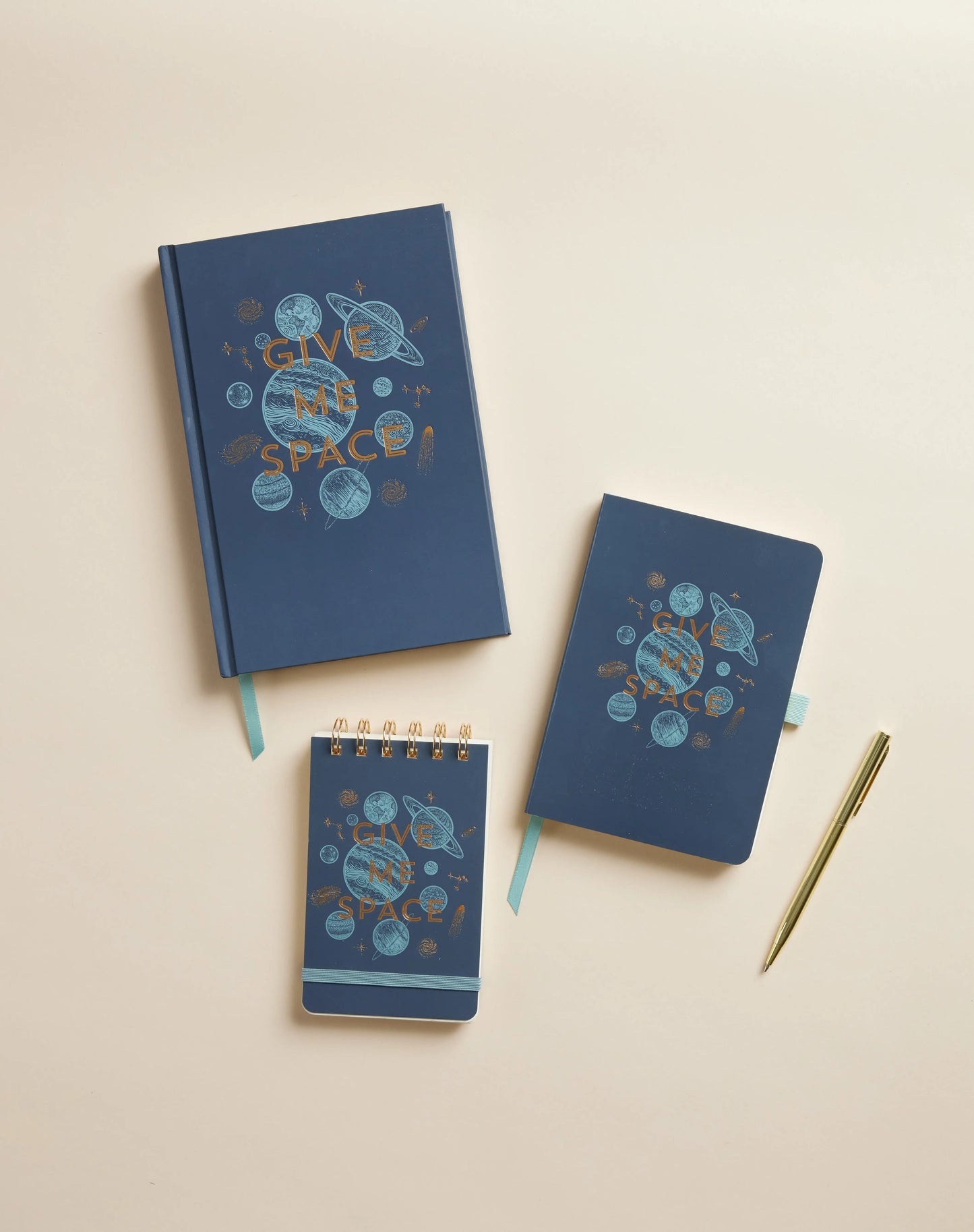 The Vintage Sass Notebook with Pen - Give me Space features an intergalactic cover and is arranged with a gold pen on a beige surface, making it perfect for capturing your stellar ideas.