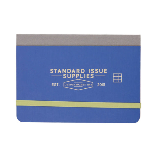 The Standard Issue Pocket Journal - Cobalt + Citron features blue and gray covers, a yellow elastic band, and a grid icon that reflects its practical grid format.