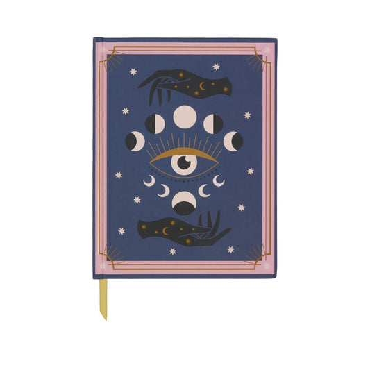 The A Dopo Moon Phases Journal (6 x 7.75) features imaginative blue covers inspired by Mediterranean travels, showcasing moon phases, an eye with rays, two hands, stars, and a yellow ribbon bookmark.