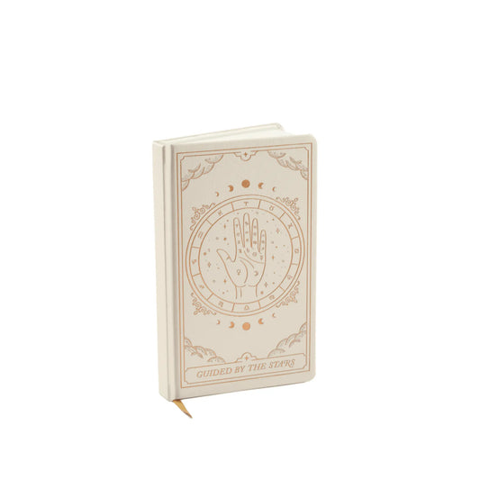 The Bookcloth Journal - Zodiac features a palmistry hand and celestial designs with gold foil accents on its beige cover—ideal for cosmic inspiration and perfect as a zodiac-themed journal.
