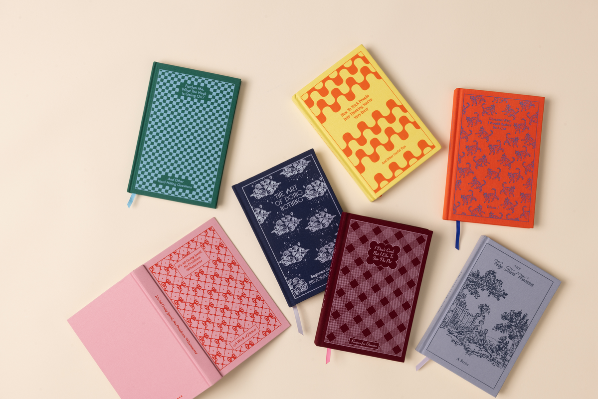 Set of colorful patterned notebooks on a beige background