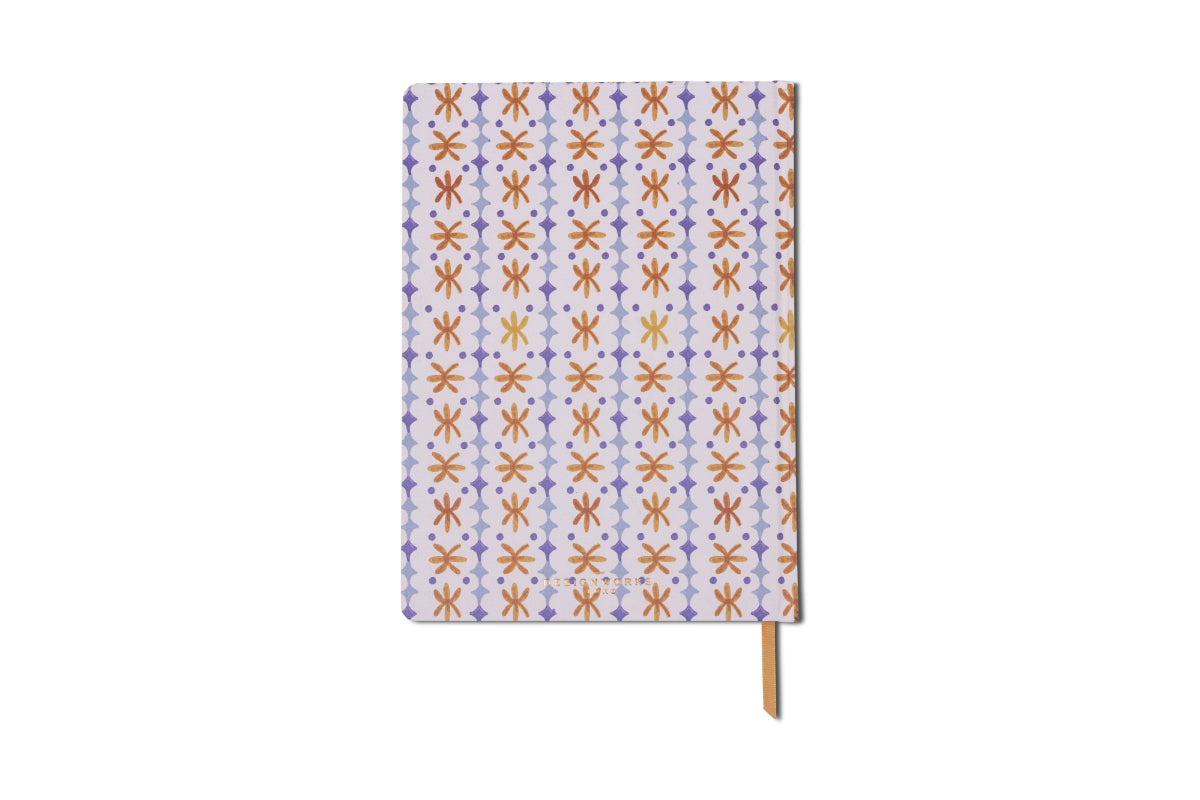 The Tulip Jumbo Journal - Marigold features a slim design with red, yellow, and purple geometric shapes on a white background, a purple striped edge, and a yellow ribbon bookmark.