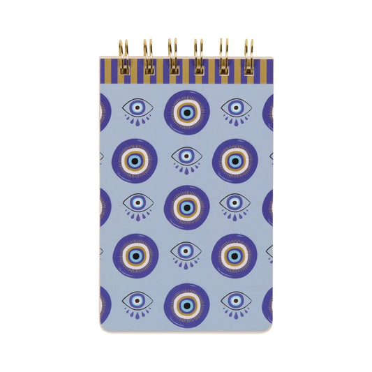 The A Dopo Eye Twin Wire Notepad is a small notepad with a blue and white Mediterranean-inspired cover featuring stylized eyes and circular designs—perfect for sparking creativity.