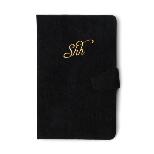A closed Mini Password Journal - Shh in black with gold cursive Shh on the cover and a side flap closure, ideal for storing confidential logins or digital secrets, displayed against a white background.
