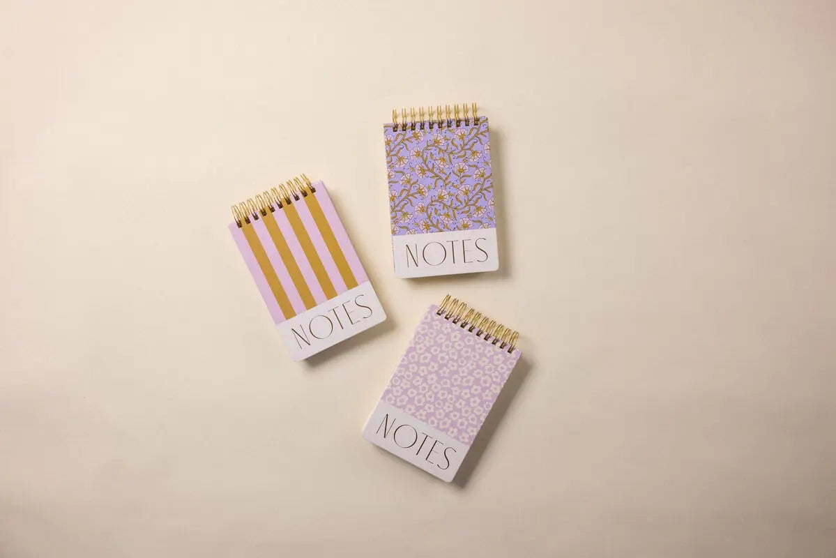 A Large Chunky Notepad featuring lilac and ochre stripes is displayed on a neutral background, with NOTES on its bold, patterned cover.