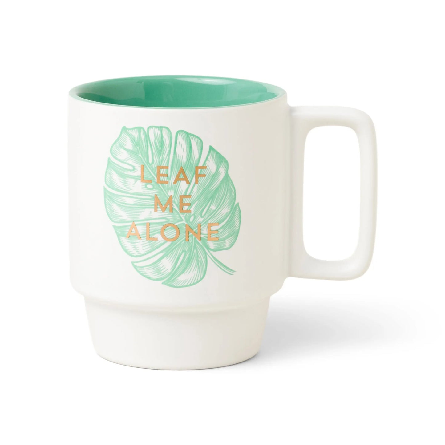 From the Vintage Sass 12 oz. Mug - Leaf Me Alone, this white ceramic mug with a green interior showcases a Monstera leaf and LEAF ME ALONE in gold lettering.