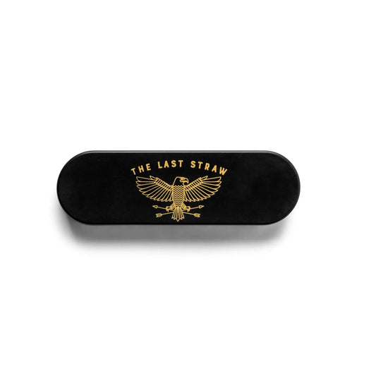 The Portable Straw - The Last Straw is a black rectangular eco case with rounded edges, featuring a gold eagle and THE LAST STRAW text—ideal for carrying reusable stainless steel straws.