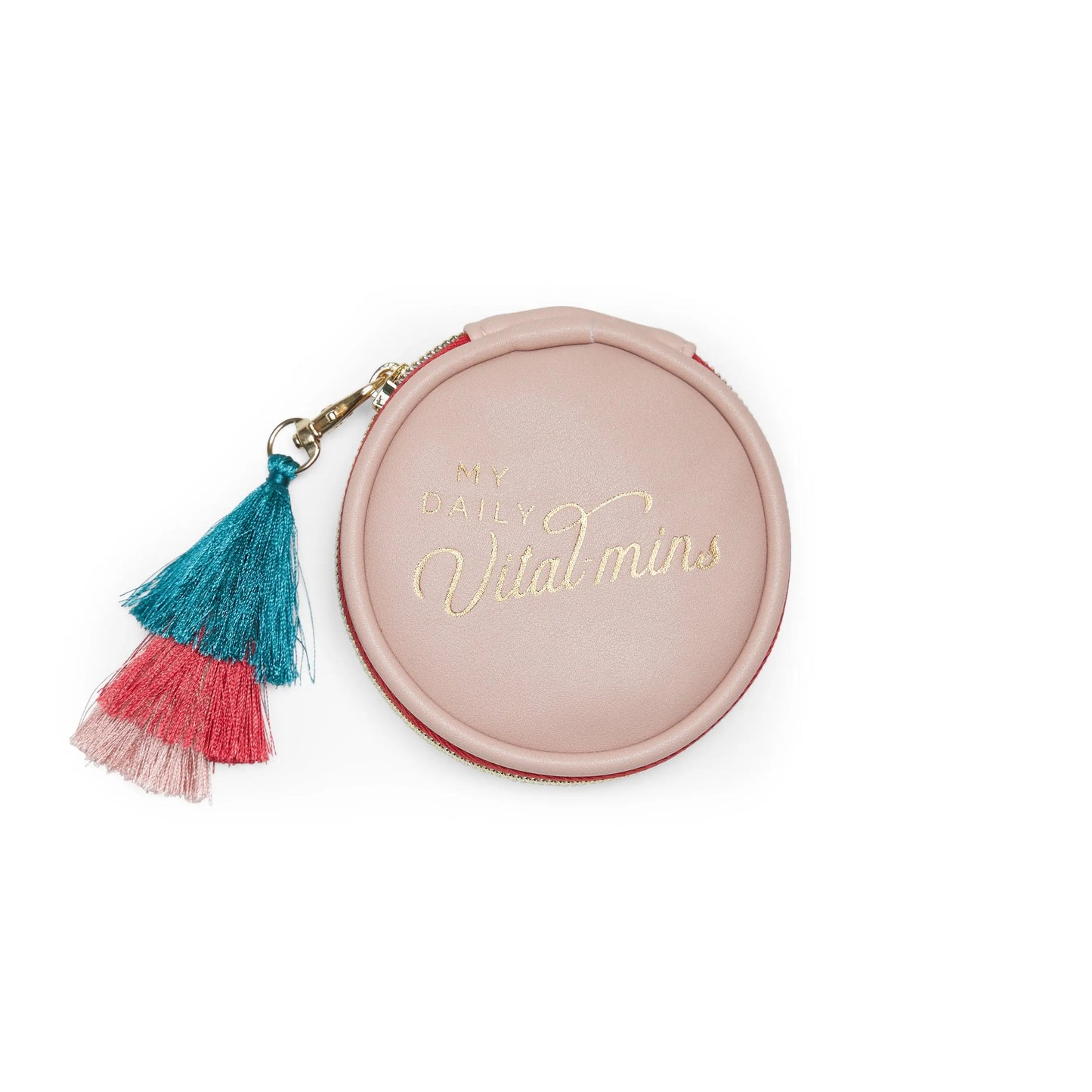 A round pink Vegan Leather Travel Pill Case with tassel, gold Daily Vital-Mins text, and a zipper pull featuring blue and pink tassels.
