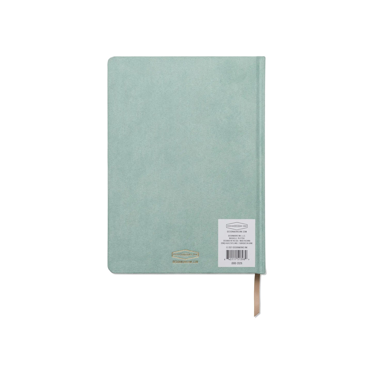 The Suede Jumbo Journal - Mineralogy is pictured in mint green, closed with a barcode sticker on the back and featuring a visible cream ribbon bookmark.