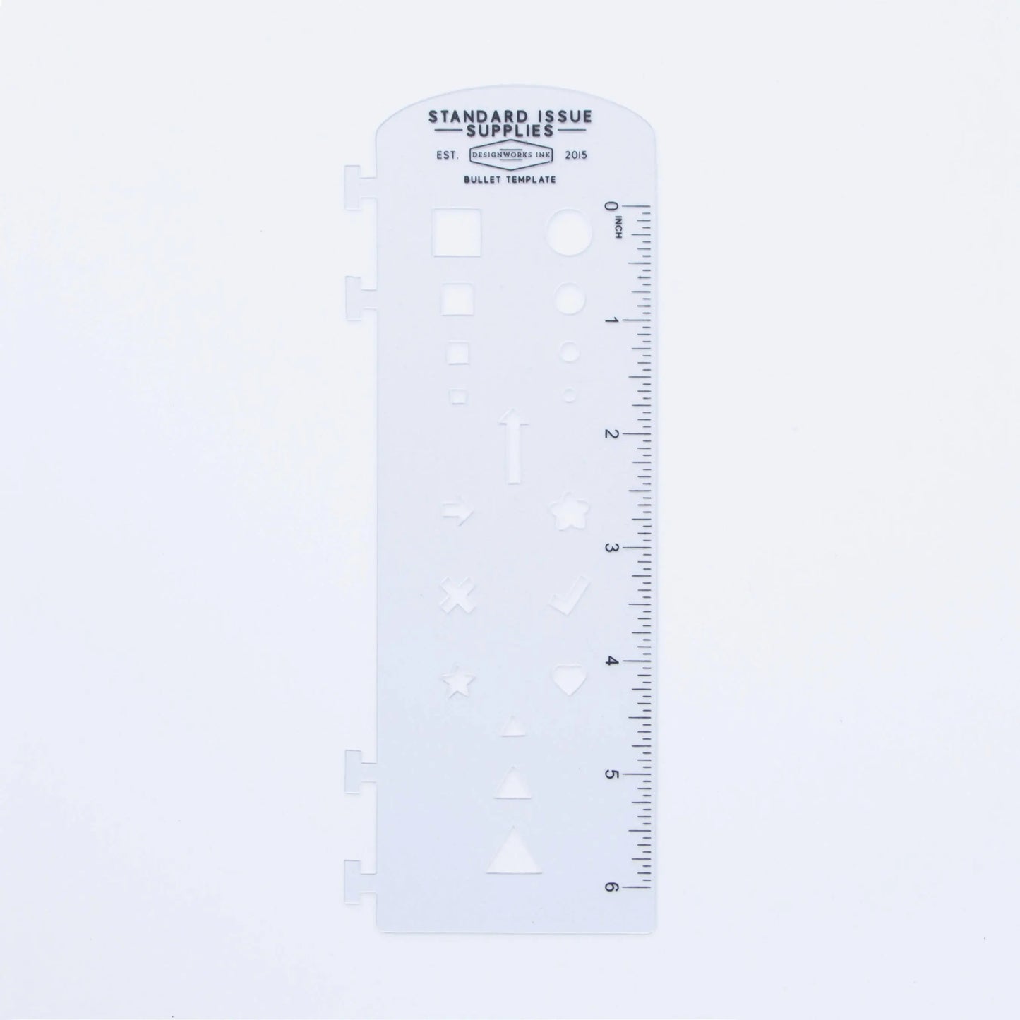 The Standard Issue Notebook No.12 - Dusty Pink features high-quality construction and pairs perfectly with the clear plastic bullet template, which includes geometric shape cutouts, a right-edge ruler, and bears the Standard Issue Supplies label.