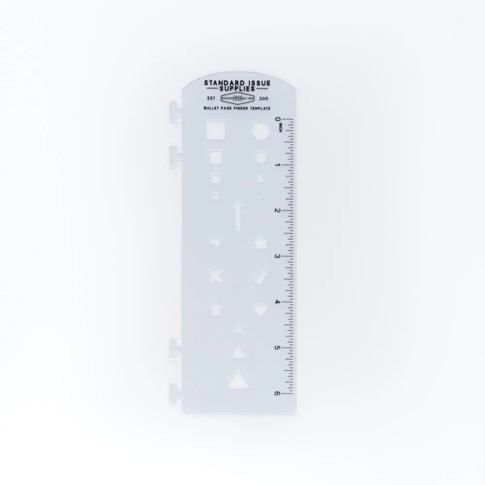 A translucent plastic stencil labeled “Standard Issue Supplies” features geometric shapes and a ruler. It’s the perfect companion for the Standard Issue Notebook No.12 - Green.