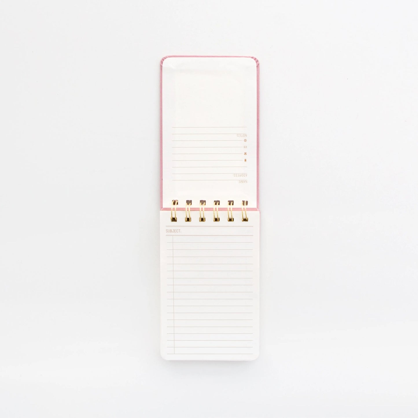 An open Suede Cloth Covered Notepad - Radiant Rainbow, featuring a Dusty Blush pink spiral-bound cover and lined acid-free paper, is placed on a white background.
