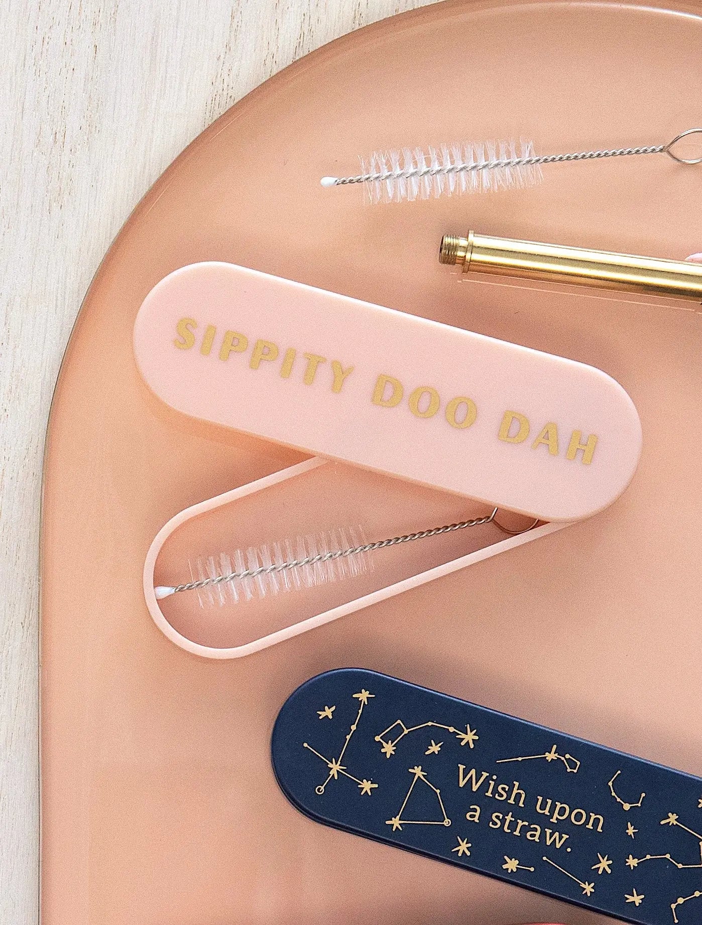 A pink Portable Straw - The Last Straw case features SIPPITY DOO DAH, while a navy one displays constellations and Wish upon a straw. Both are perfect for carrying your premium 18/8 stainless steel straws.