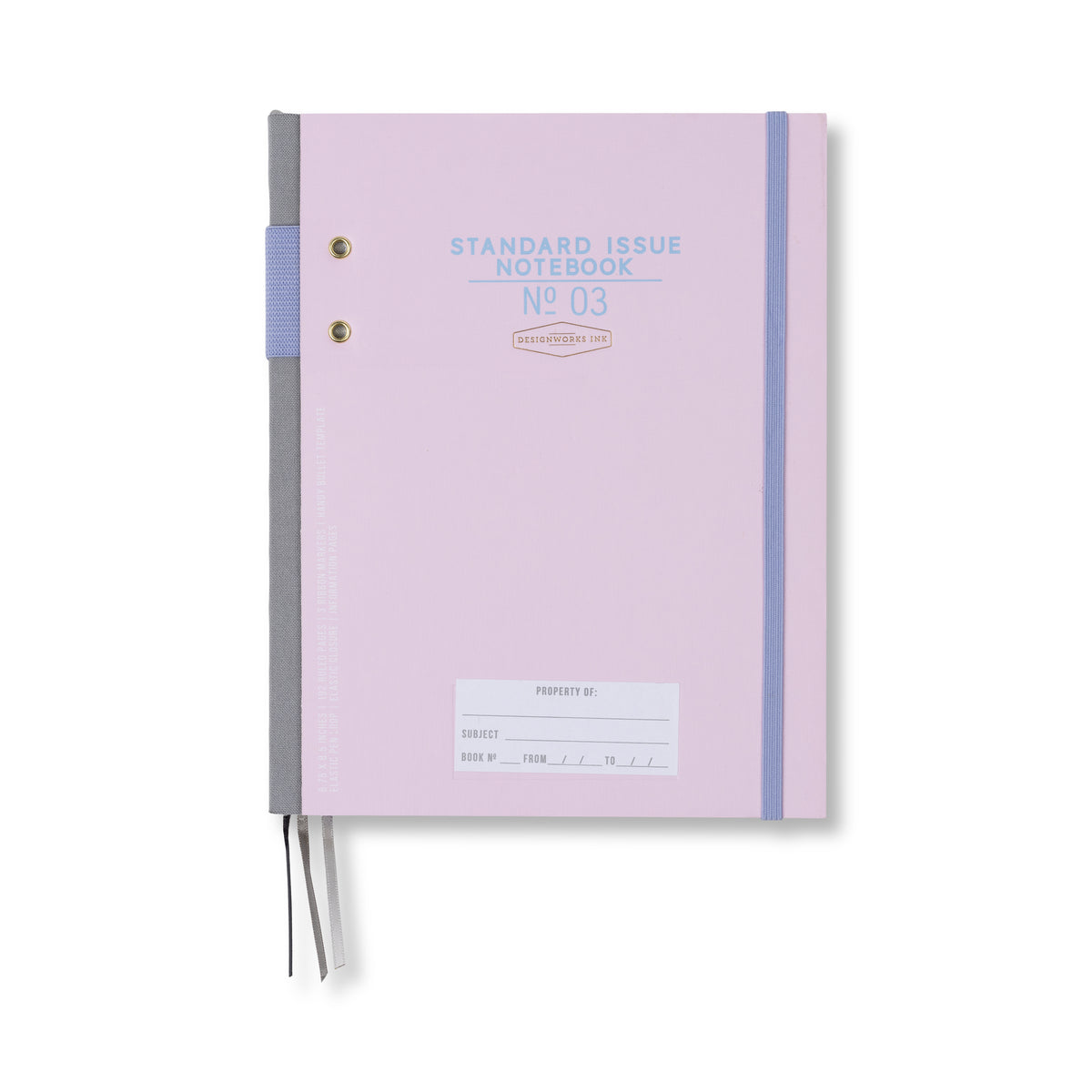 The Standard Issue Planner Notebook No. 03 in Lavender + Periwinkle features a pastel purple cover, a gray spine, elastic closure, two ribbon bookmarks, and a small subject label area at the bottom.