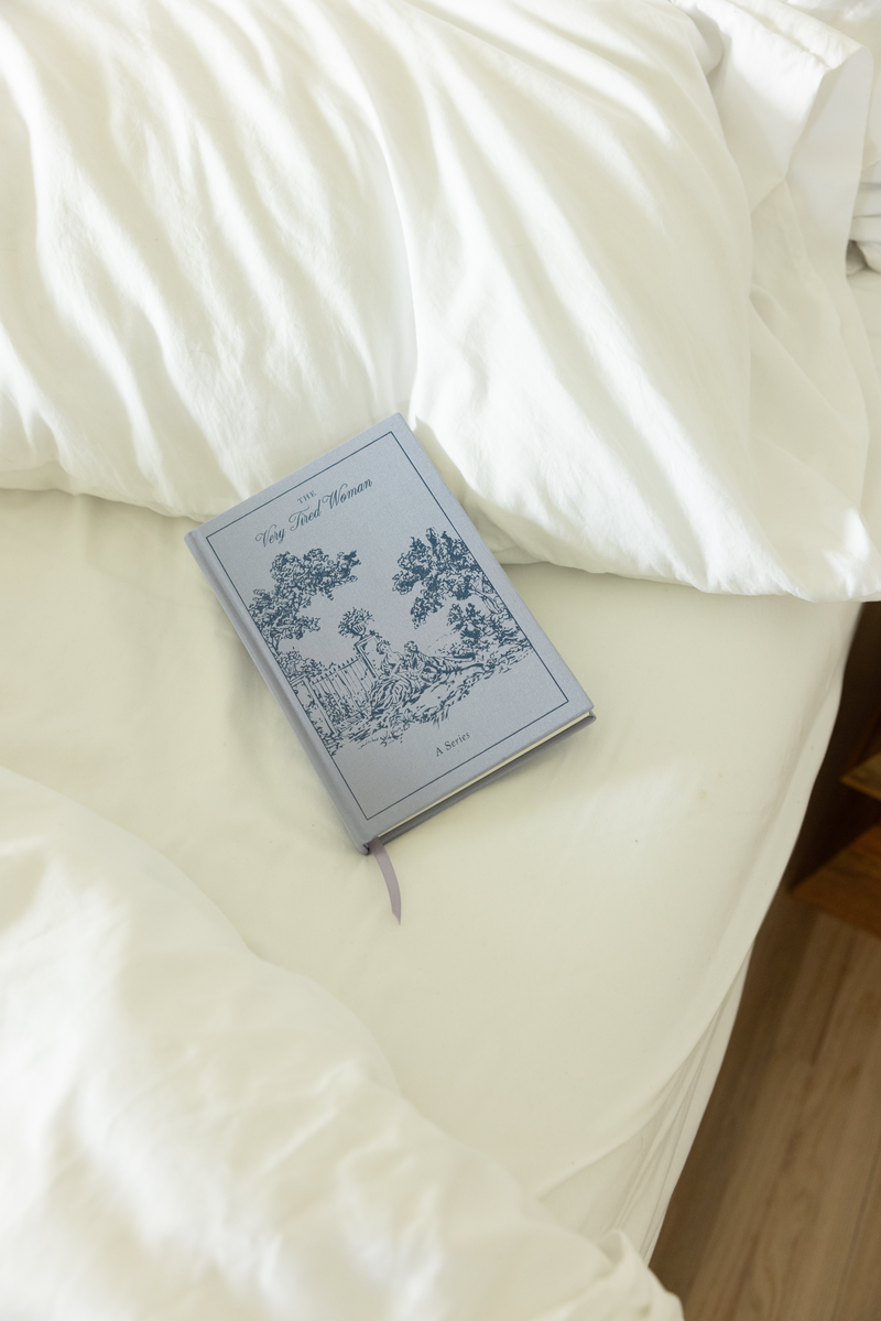 Notebook with decorative cover on a white bed