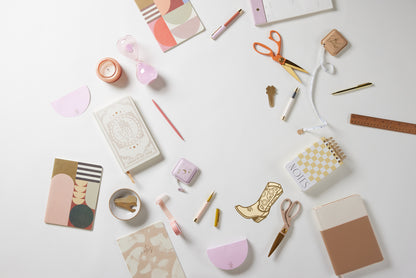 A flat lay of assorted stationery, featuring the Washi Tape Set of 3 - Plant Lover, along with a planner, notebooks, scissors, pens, ruler, sticky notes, an hourglass, a candle, and decorative paper on a white surface.