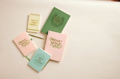The Vintage Sass Notebook with Pen - Froget about it features a playful pastel cover and witty text, making it perfect for creative notes or as a unique gift.
