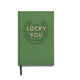 Introducing the Vintage Sass Journal - Lucky You: This green hardcover journal features a charming horseshoe and clover illustration, with “Lucky You” elegantly stamped in gold foil on the cover. A matching green ribbon bookmark adds function and flair, making it a delightful gift or a unique vintage keepsake for anyone enchanted by luck.
