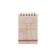 The Vintage Sass Notepad - Shiitake Happens features a small spiral-bound design with a pink mushroom illustration, gold lettering, and a pink elastic band—ideal for adding vintage flair to your daily notes.