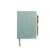 The "Gratitude Journal with Pen - You Are Exactly Where You Need To Be" features a light blue cover with gold text, sun, stars, and crescent moon illustrations. It includes a gold pen attached to the side and a gold ribbon bookmark.