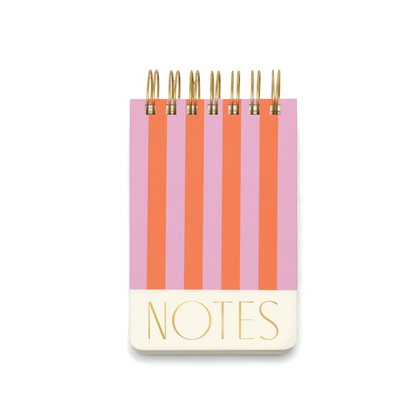 The Chunky Small Twin Wire Notepad - Stripes features a spiral binding, alternating pink and orange vertical striped cover, and "NOTES" in gold foil at the bottom.