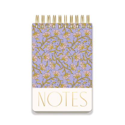 The Large Chunky Notepad - Purple Vintage Floral is a spiral-bound, hard cover notepad with a purple cover featuring pink and yellow flowers and "NOTES" in large gold letters at the bottom.