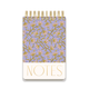 The Chunky Large Twin Wire Notepad - Purple Vintage Floral is a spiral-bound pocket notepad with a hard cover, purple and pink floral design, "NOTES" in gold at the bottom, and 192 sheets.