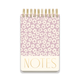 A chunky large twin wire notepad with a lilac groovy floral cover design and "NOTES" in bold gold at the bottom, featuring lined pages for convenient writing.