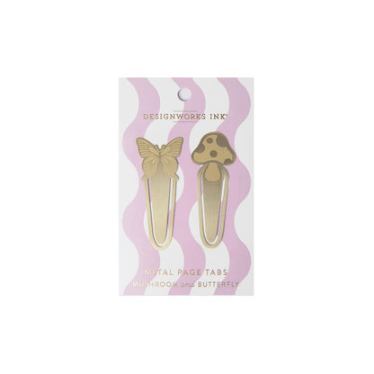 The Brass Page Tabs - Mushrooms + Butterfly set from DesignWorks Ink includes two brass bookmark tabs shaped like a butterfly and a mushroom, displayed on a white card with pink wavy stripes.