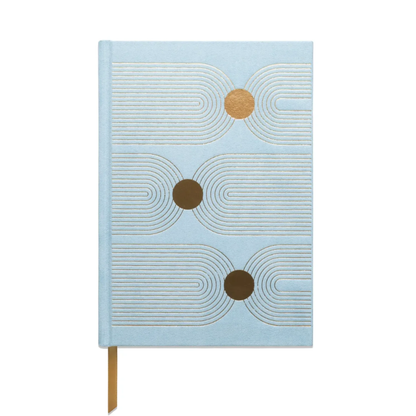 The Hard Cover Suede Cloth Journal With Pocket - Arch Dot features a light blue cover, gold ribbon bookmark, abstract geometric white lines, and three large gold circles arranged vertically.