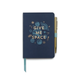 The Vintage Sass Notebook with Pen - Give Me Space features a navy blue cover adorned with gold and blue planets and stars, along with the phrase “GIVE ME SPACE” in gold. A gold pen is conveniently attached to this intergalactic journal using a light blue elastic loop.