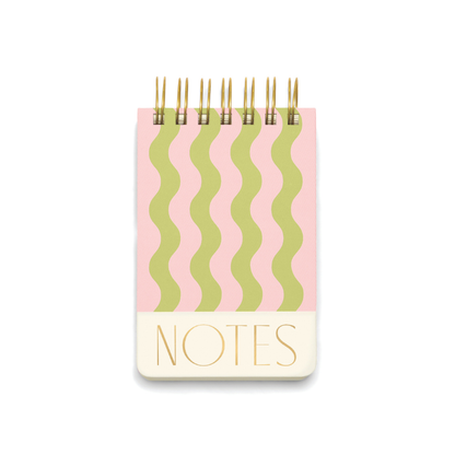 The Chunky Small Twin Wire Notepad - Wavy Stripes features a spiral binding, green and pink wavy striped cover, and "NOTES" in gold at the bottom.