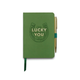 The Vintage Sass Notebook with Pen - Lucky You features a green cover decorated with a charming horseshoe design and the phrase “Lucky You,” and comes paired with an attached gold pen.