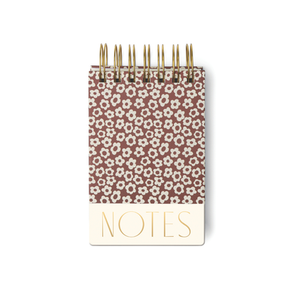 The Chunky Small Twin Wire Notepad - Burgundy Groovy Floral features a compact 4x6 size, twin wire binding, and a burgundy cover with white floral patterns. Gold "NOTES" lettering on the cream bottom section makes it ideal for on-the-go note-taking.