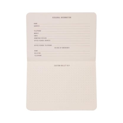 The Standard Issue Pocket Journal - Black features sections for personal information, emergency contacts, and a customizable bullet key on dotted paper. With blank pages ready to be filled in, it’s perfect for use as a travel journal or for daily note-taking.