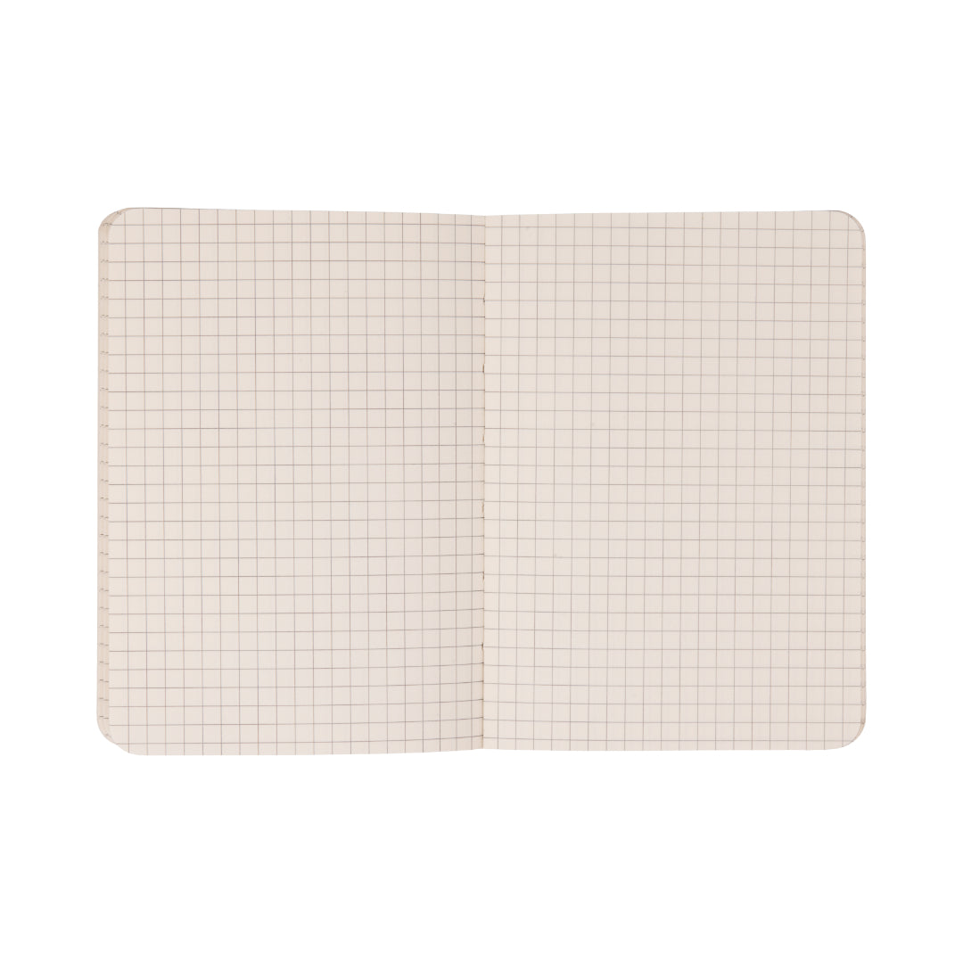 The Standard Issue Pocket Journal - Rosewood + Blush, featuring squared, grid-patterned pages and rounded corners, is shown lying flat on a white background.