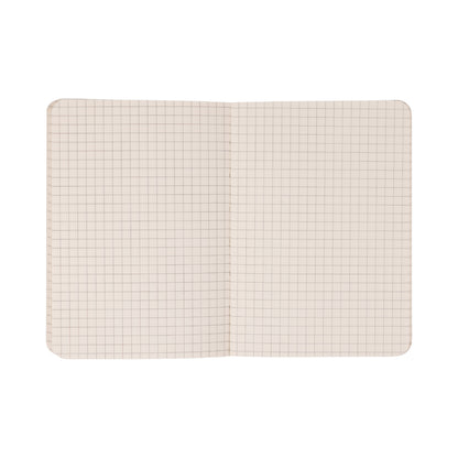 The Standard Issue Pocket Journal - Rosewood + Blush, featuring squared, grid-patterned pages and rounded corners, is shown lying flat on a white background.