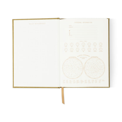 The Radiant Journal - Avocado is an eco-friendly, lay-flat notebook with a dotted left page and a right page for personal details, including fields for your name, address, and diagrams of world times and celestial phenomena.
