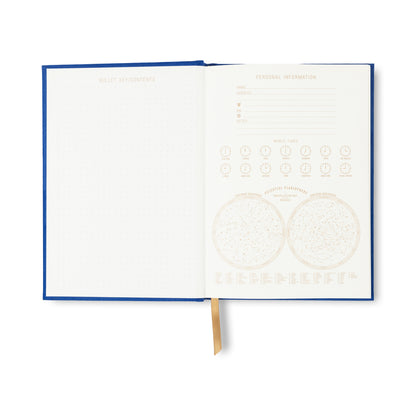 The Radiant Journal - Cobalt features 160 lined pages, a dotted contents page, personal info section, moon phases, constellation diagrams, gold ribbon bookmark, cobalt suede cloth cover, and a lay-flat sewn binding.