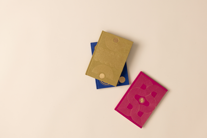 three colorful notebooks on beige background