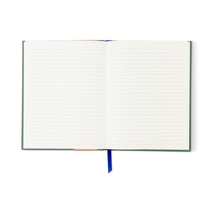 An A Dopo Peacock Journal with a soft-touch cover, blank lined lay-flat pages, and a blue ribbon bookmark is shown from above on a white background.