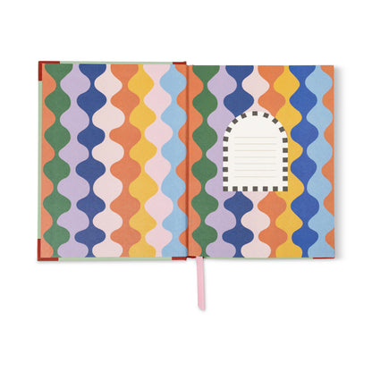Colorful patterned notebook with a pink ribbon on a white background