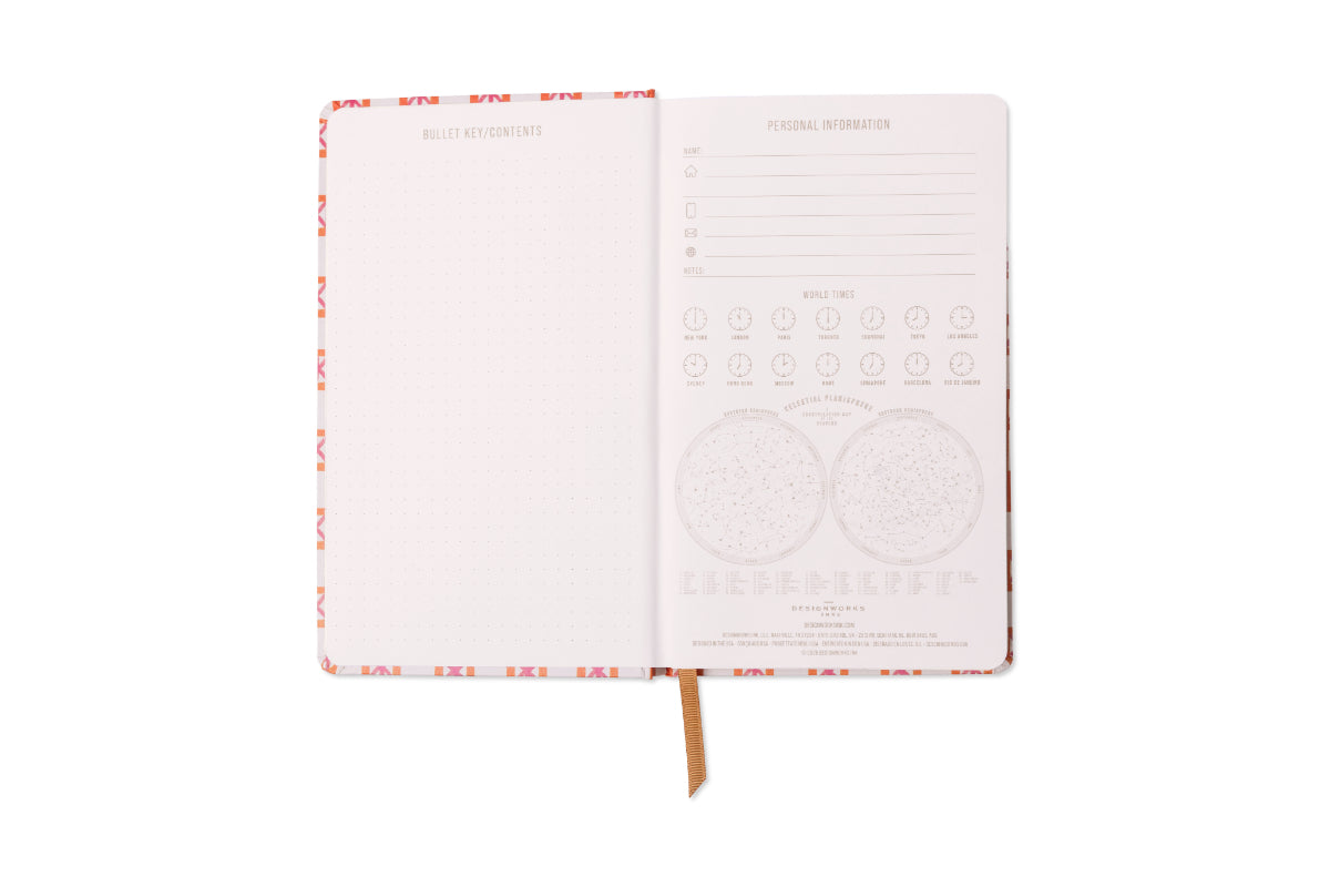 The Tulip Journal - Orange Check is open to a dotted left page and a right page for personal info, contact details, mood tracking icons, and star maps. A brown ribbon bookmark accents this vibrant journal.