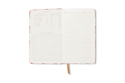 An open Tulip Journal - Tropical reveals a lined page on the right and measurement conversion charts with tables and equivalents on the left, plus a gold ribbon bookmark centered between the pages.